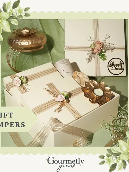 An overview of our Diwali Gift Hampers, showing the elegant white boxes with custom "Happy Diwali" tags and decorative diyas.