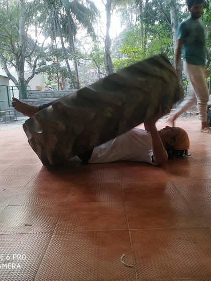 The tire press is a test of pure strength. This is part of our rigorous conditioning program.