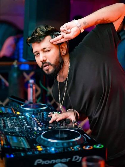 A playful pose while mixing. I'm the headliner of my own story, and every night is a new chapter.