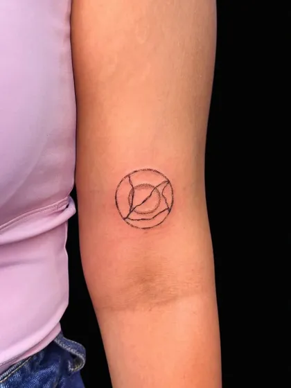 A small, abstract geometric symbol on the arm. The clean, intersecting lines create a simple yet intriguing piece.