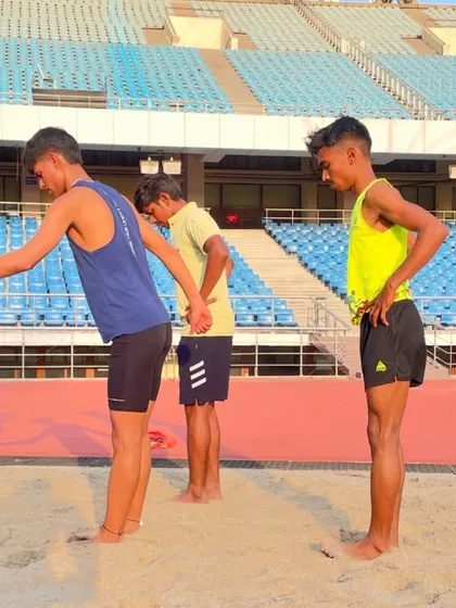 Partner-assisted stretching in the sand pit after a tough workout. This helps improve flexibility and aids in muscle recovery, an essential part of our cool-down routine.