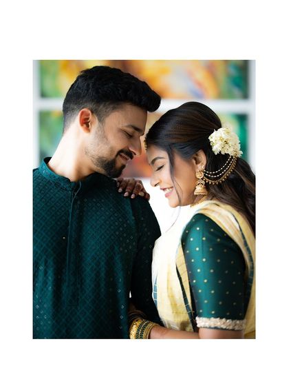 A sweet and intimate portrait of an engaged couple. The bride's traditional jasmine hair accessory and their gentle smiles add to the charm.