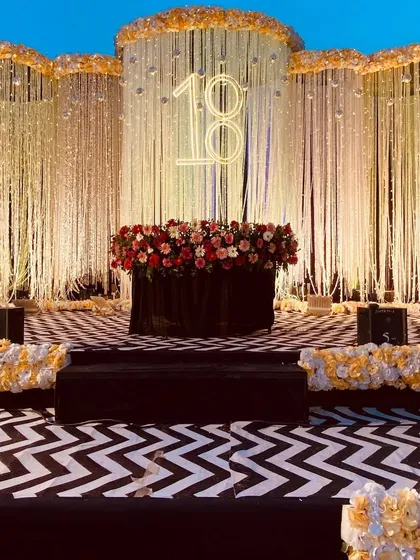 A wider view of the 18th birthday stage, showing the full black-and-white chevron floor and the tiered setup, perfect for photos and cake cutting.