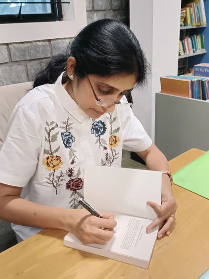 Another shot of author Pika Nani signing books, a popular activity after her engaging session.