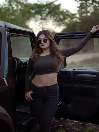 A duplicate of image 207, this portrait of a model with a Thar jeep at sunset is powerful and atmospheric.