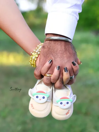 A close-up of a couple's hands holding a tiny pair of baby shoes. This symbolic shot is filled with hope, dreams, and the promise of new adventures to come.