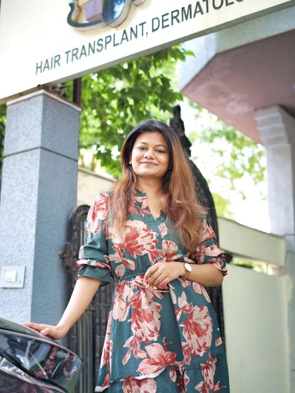 Standing outside my clinic, AISHH, a place dedicated to hair transplant and dermatology. My mission is to make expert skin and hair care accessible to everyone.