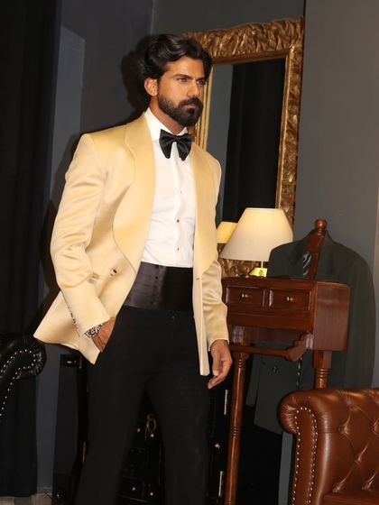 Paired with a black cummerbund, the ivory tuxedo is the epitome of black-tie style.