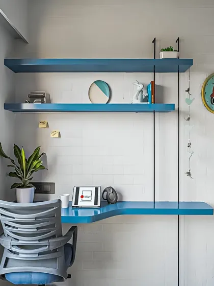 A minimalist wall-mounted study unit in a vibrant blue. This space-saving design is perfect for a small corner, providing a functional desk and shelving without a large footprint.