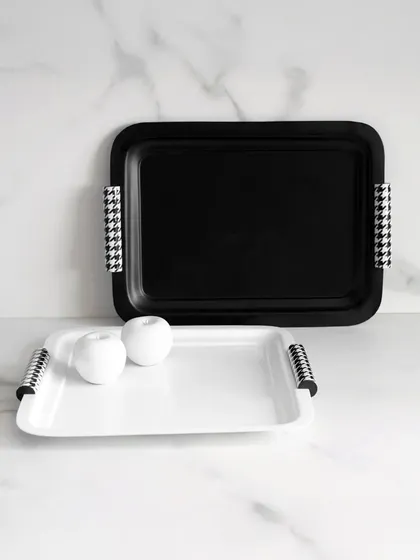 Timeless by design. These black and white trays from the Uma Black Collection, with their classic houndstooth-patterned handles, embody sophistication, minimalism, and quiet luxury.