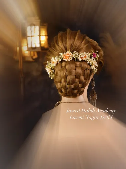 Another view of a stunning basket-weave updo, this time crowned with a floral accessory. Our students master a variety of braiding and weaving techniques.