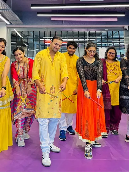 A candid moment from our Day 1 Navratri dandiya session. Everyone is focused on getting the steps right while still having a great time together.