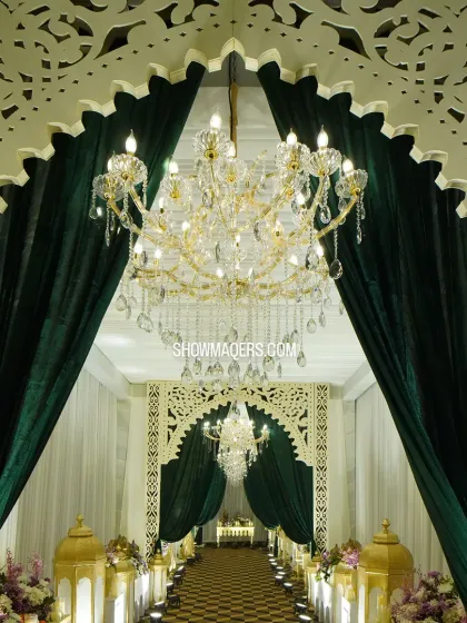 A grand entrance sets the tone for an exceptional event. For this evening gala, we created a stunning entryway with lush green velvet drapes, intricate laser-cut arches, and magnificent crystal chandeliers to welcome guests into a world of elegance.
