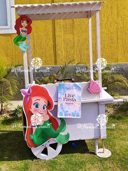 Food stations can also be part of the theme. This live pasta station is cleverly integrated into a mermaid-themed cart for an outdoor party.
