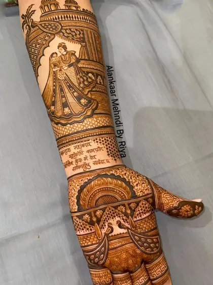 The completed arm design, featuring a romantic couple portrait under a traditional archway, with a Sanskrit verse adding a deeply personal touch.