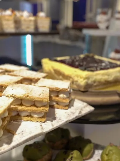 A close-up of our dessert selection, featuring delicate mille-feuille pastries and a classic blueberry cheesecake.