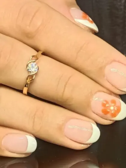 Another angle of the floral French manicure, showing a thin silver line separating the tip for added detail.