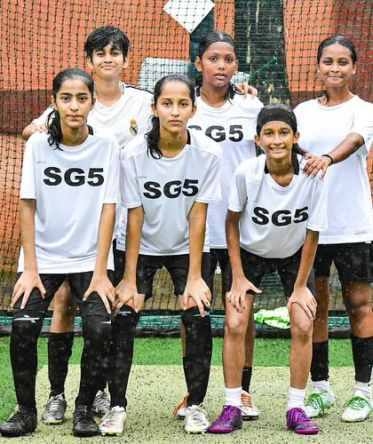 The SG5 girls' team posing together. We are building a strong community of female footballers.