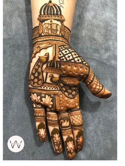 Another angle of the royal peacock design, showing the swan and lotus details on the fingers.