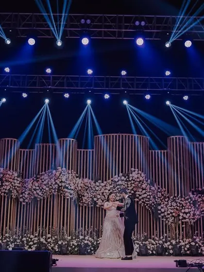 The first dance on a spectacular stage. We use dramatic lighting and wide angles to capture the scale of your sangeet or reception decor, making your performance look as grand and cinematic as it felt.