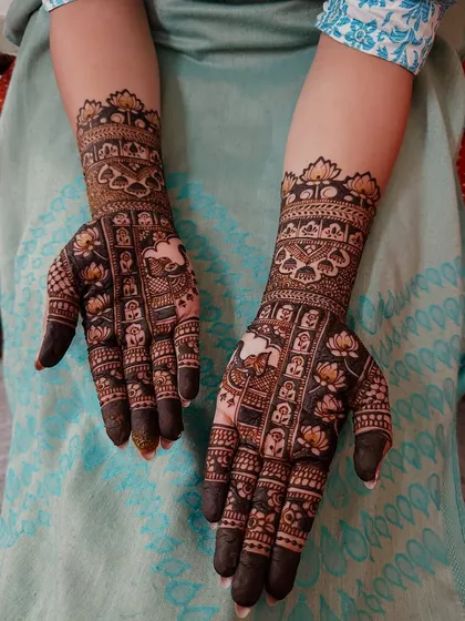 This intricate design features repeating blocks of lotus and elephant motifs, creating a narrative pattern that is perfect for a festive or bridal occasion.
