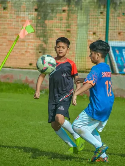 A player chests the ball down from a corner kick, showing excellent control and preparing for the next move.
