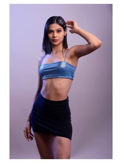 A fun and energetic studio shot with creative lighting. The pose and accessories give this portrait a modern, pop-inspired vibe.