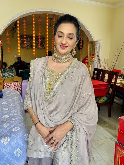 An elegant look for a guest at a wedding. The makeup is sophisticated and understated, with a focus on glowing skin.