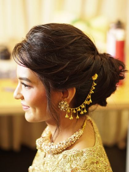 A side profile showing the elegant hairstyle and makeup details. This look is perfect for any special occasion, providing a polished and sophisticated finish.