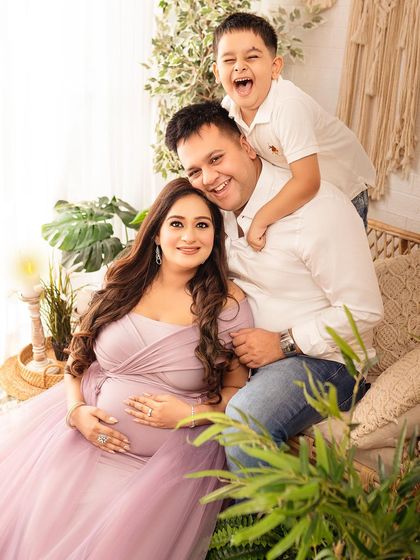 Pure joy. This photo captures the genuine laughter and love of a family excited to welcome their newest member.