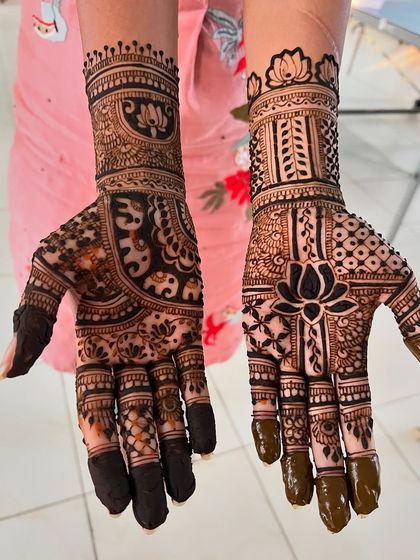 This mid-arm design features a central lotus, surrounded by a mix of traditional patterns and negative space.