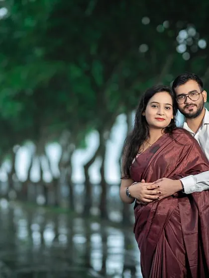 A classic, cozy embrace on a rainy day. The soft, diffused light and the blurred green background create a dreamy and intimate portrait.