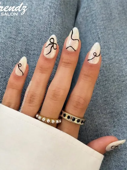 For a modern and chic vibe, I hand-painted these abstract black lines and delicate bows over a clean white base on these almond-shaped extensions. This design shows how minimalist nail art can still be incredibly eye-catching and unique.