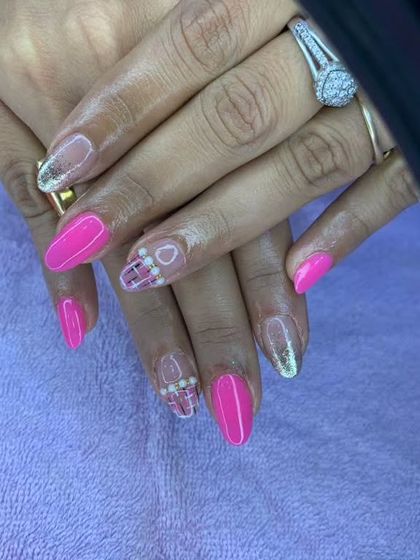 A bright pink set with plaid-patterned accent nails featuring tiny pearls.