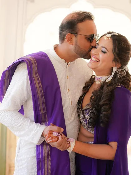 A sweet kiss on the cheek during the Mehendi ceremony. We capture the love and affection between the couple amidst the fun and festivities.