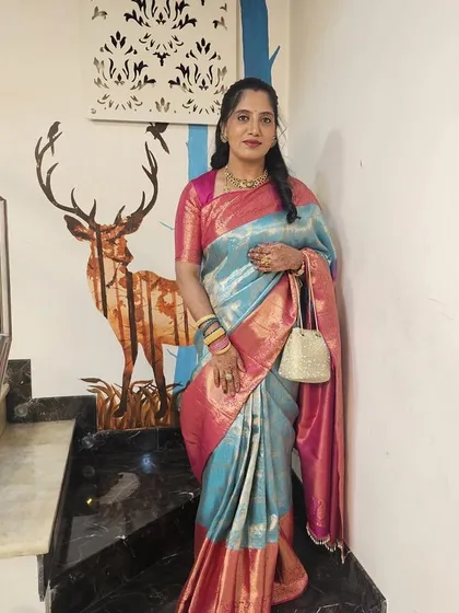 Vijetha's full look, complete with a traditional potli bag, perfect for a wedding or festive event.