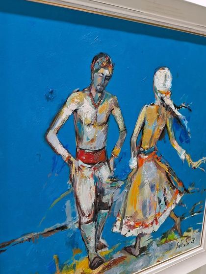 An expressive painting of two dancers against a bold blue background, seen at World Art Dubai.