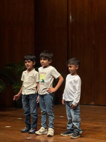 Three boys strike a pose during their performance, showing the confidence and attitude they've developed.