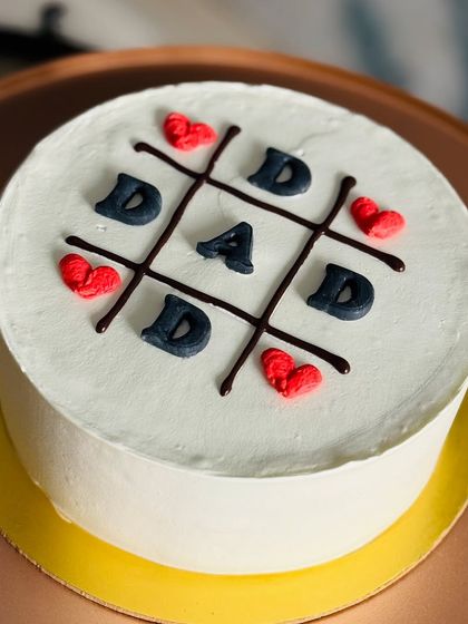 A simple yet sweet tic-tac-toe design spelling out "DAD" for Father's Day, made with my popular red velvet cake.