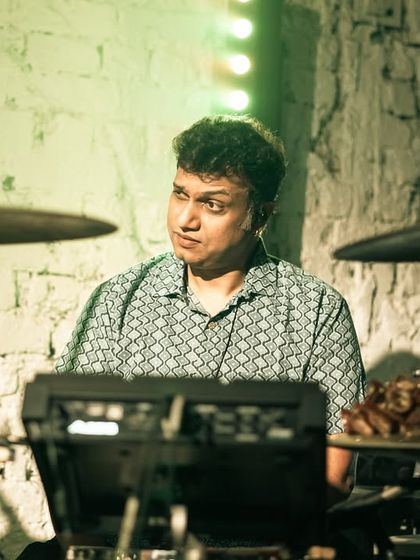 A close-up of our drummer's intricate setup. His combination of a standard drum kit with electronic pads allows for a wide range of sonic possibilities.