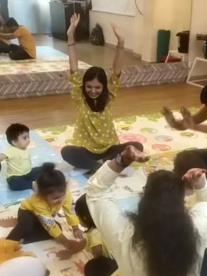 We use our whole bodies to learn about music. Here, we are all reaching for the sky as part of a song, a fun activity that helps with gross motor skills.