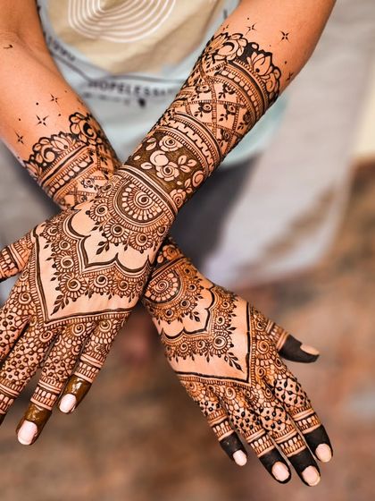 A slightly different angle of a classic engagement design, showing how the patterns wrap beautifully around the hands and arms.