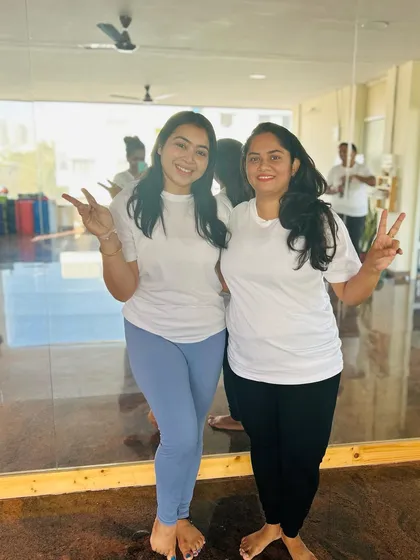 Two students celebrating their accomplishment with a victory sign. The sense of achievement and camaraderie was palpable.