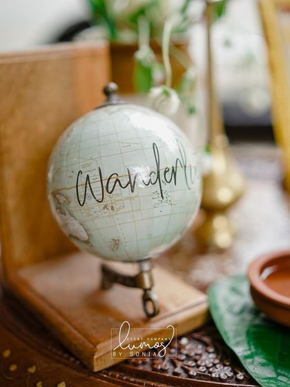 Another shot of the "Wanderlust" globe, symbolizing the couple's shared love for travel and adventure.