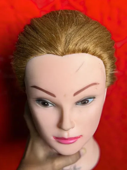 Every student starts with the basics. This is a mannequin head prepped and ready for a hands-on styling session at my hair academy.
