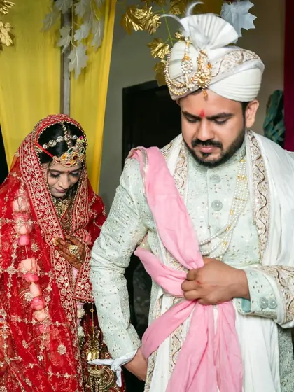 The tying of the nuptial knot. This photo captures the couple during the pheras, a central part of the wedding ceremony.