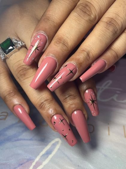 A full view of the classy star-adorned manicure, showing the clean shape and detailed artwork.
