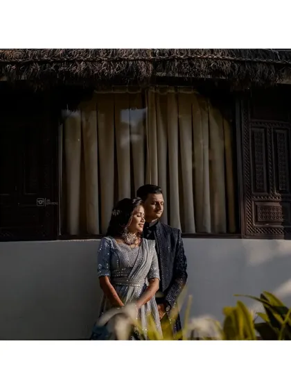 A beautifully lit portrait using natural light and shadows. The couple is framed by the architecture, creating a quiet and romantic mood.