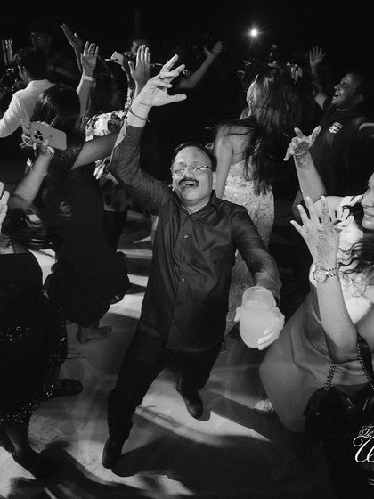 Guests letting loose and dancing their hearts out, captured in a dynamic black and white shot.