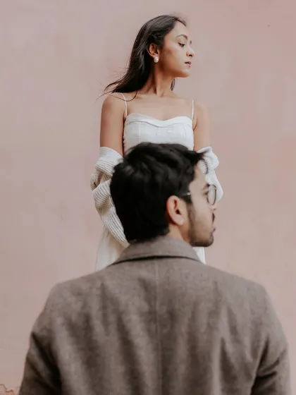An editorial-style portrait against a simple pink wall in Nice. This image from Brinda and Jeet's pre-wedding shoot on the French Riviera showcases our focus on mood and composition.